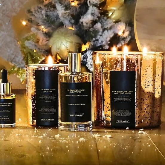 A selection of FOX & WOLF’s handcrafted Christmas candles and diffusers in elegant glass containers, showcasing the holiday spirit.